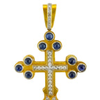 Gold cross pendant with blue round stones and central diamond line, front view