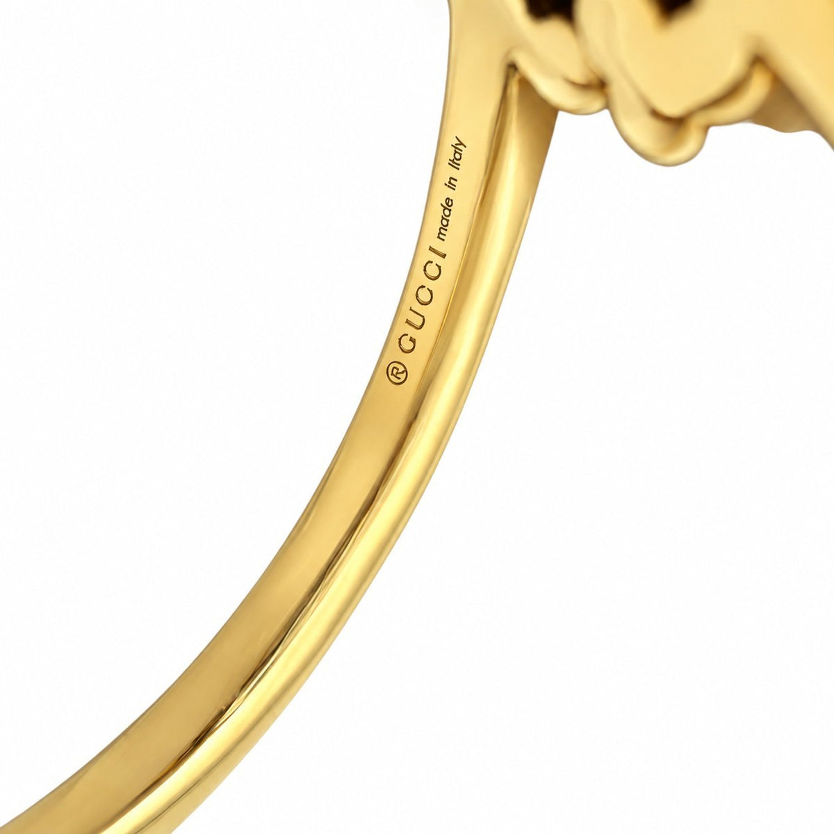 18K yellow gold ring shank close-up with Gucci engraved logo text