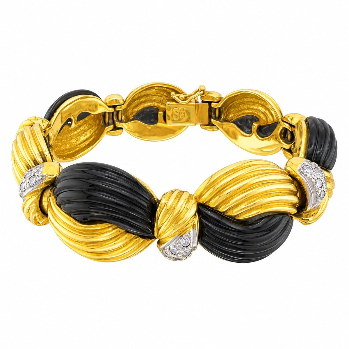 Gold and black onyx bracelet laid open to show its interlocking links and clasp