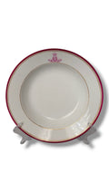 Porcelain dinner plate with red rim, gold band, and small crown crest on white center