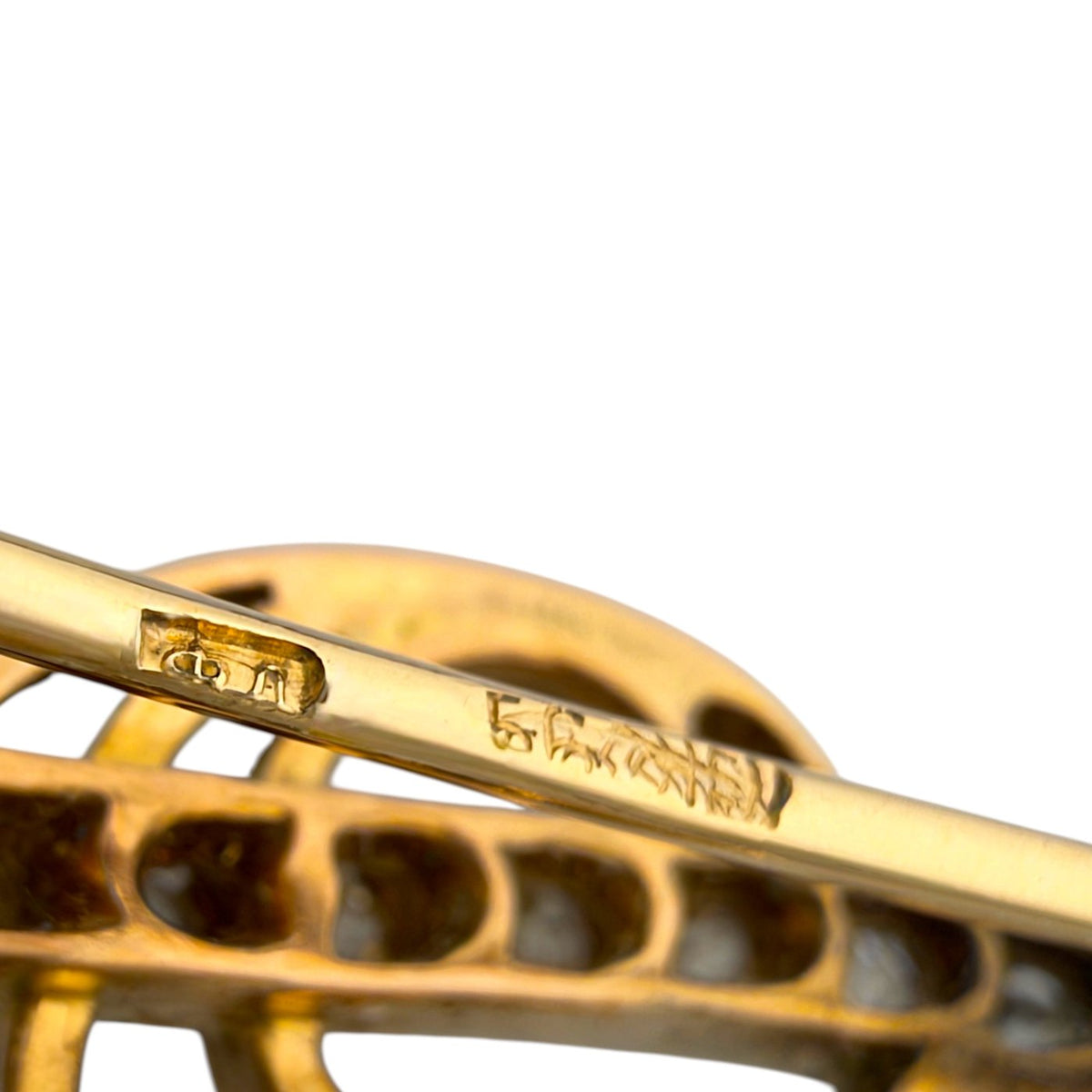 Close-up of the brooch pin with gold hallmark stamps