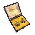 Faberge scenic enamel cufflinks displayed in an open presentation box at an angle