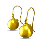 18K yellow gold ball dangle earrings shown from an angled view
