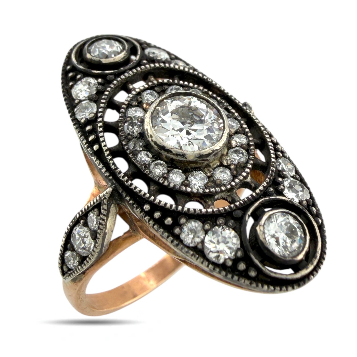 Antique rose gold diamond ring with dark bezel setting and oval center stone