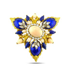 Gold-tone floral enamel brooch with blue teardrop accents, white diamond-like stones