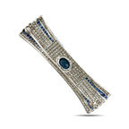 Diamond bar brooch angled view with blue sapphire stripe borders and oval blue center stone