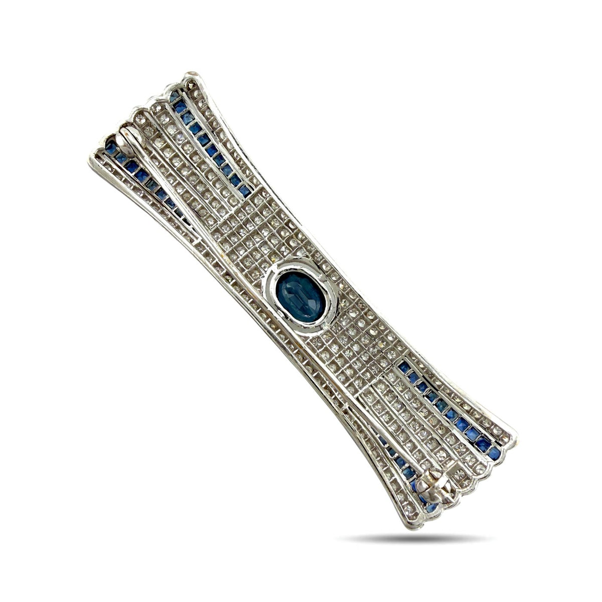 Diamond bar brooch angled view with blue sapphire stripe borders and oval blue center stone