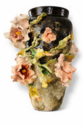 Decorative ceramic vase with black glaze, cream body, and pastel flower relief