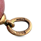Engraved gold tone oval ring detail connected to the egg pendant top bale.