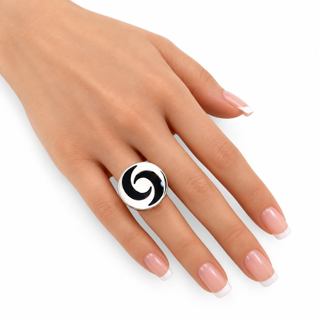 Yin-yang spinning top ring on hand with glossy black-and-white top