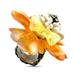 Orange and gold flower ring with pearl-like center and small sparkling stone accents