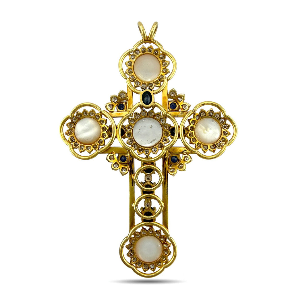 Gold cross pendant with pearl bezels, blue stone accents, and diamond trim