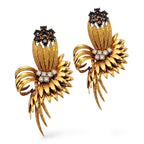 Gold fan earrings with dark blue crown stones, diamond clusters, and long gold fringe