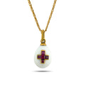 White egg pendant necklace with a gold-tone setting and ruby cross