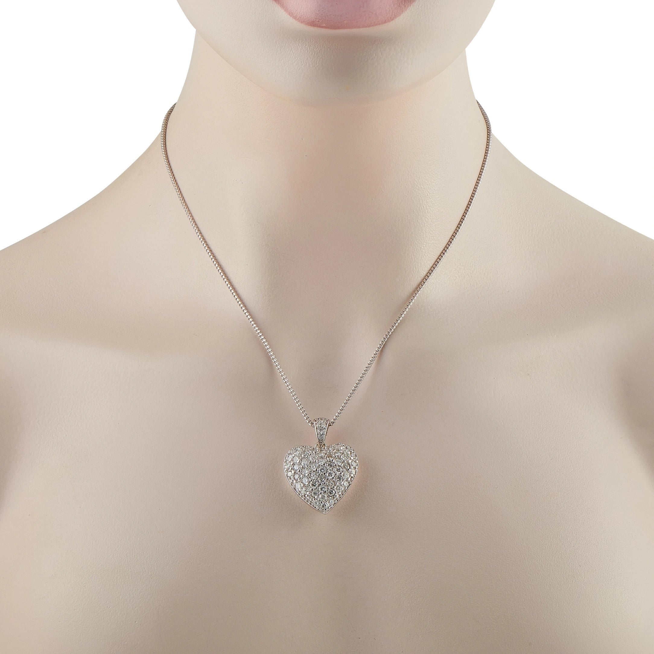 Heart diamond pavé pendant in white gold on a necklace chain at collar.