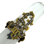 Letter opener close-up: ornate gold-tone handle with diamond-like accents on clear blade