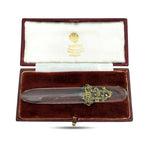Letter opener in open presentation box with clear blade and ornate gold-tone diamond-like accents