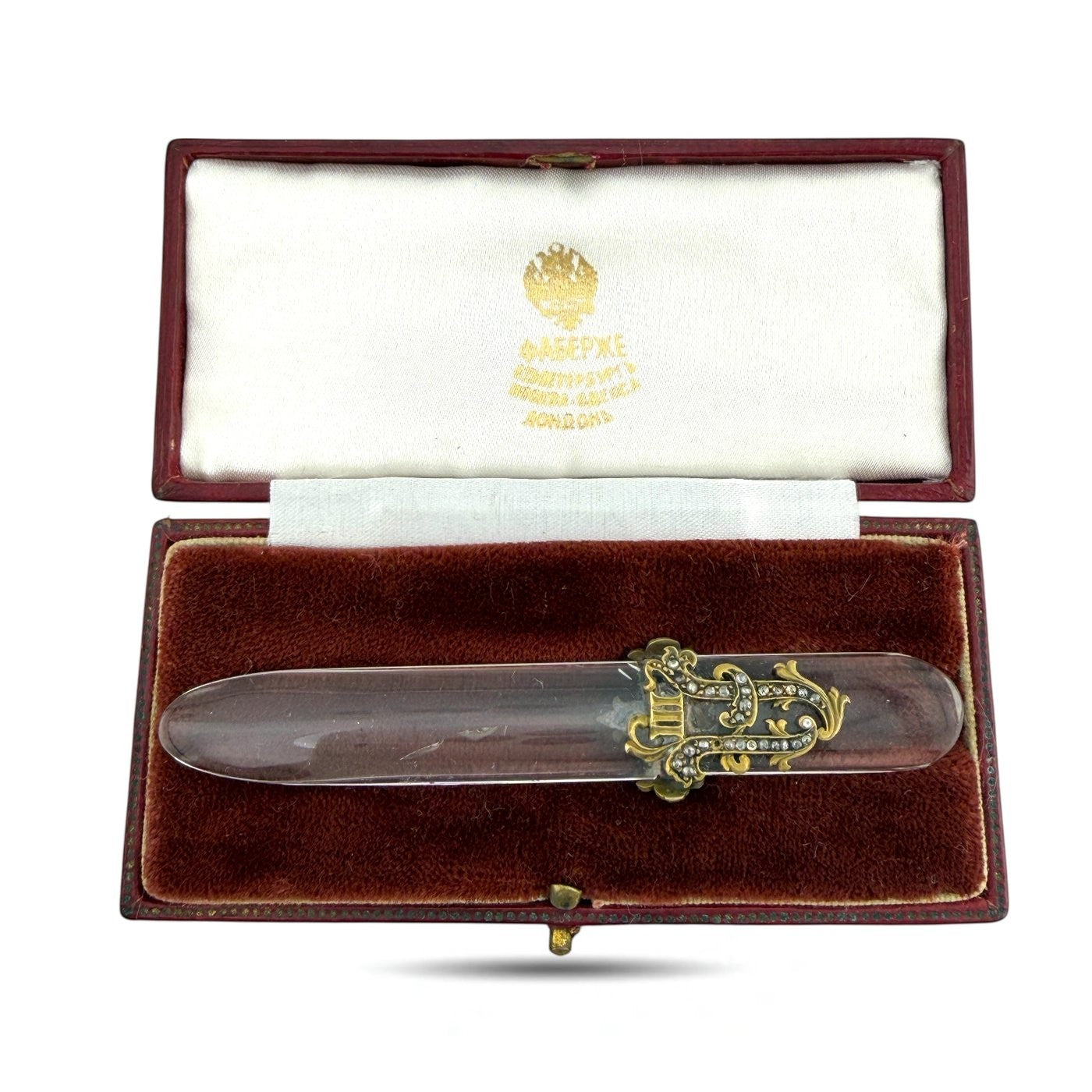 Letter opener in open presentation box with clear blade and ornate gold-tone diamond-like accents