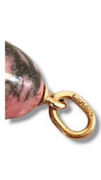 Gold bail clasp and close-up of pink egg pendant with dark veining