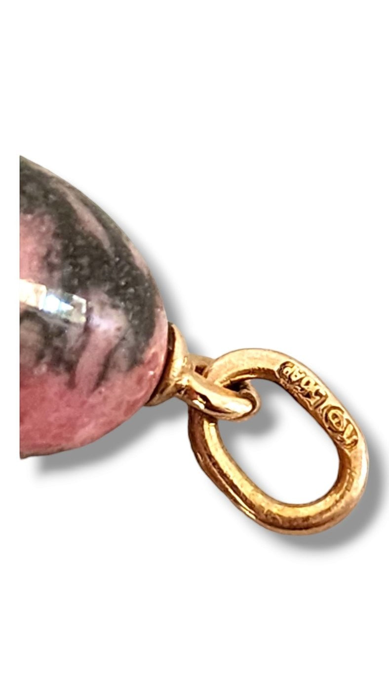 Gold bail clasp and close-up of pink egg pendant with dark veining