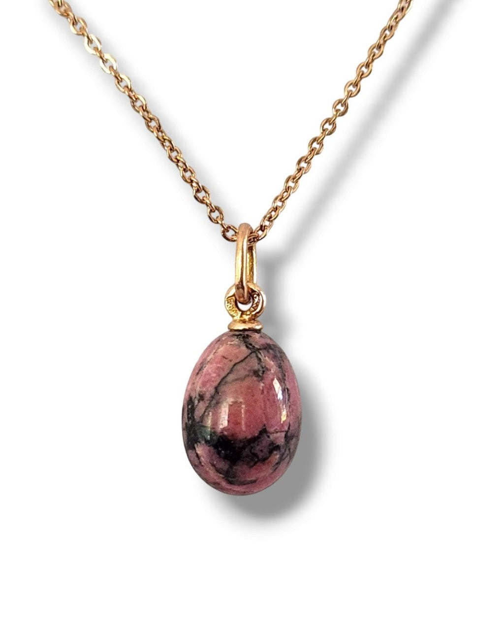 Gold chain necklace with oval pink egg pendant in ornate gold bail