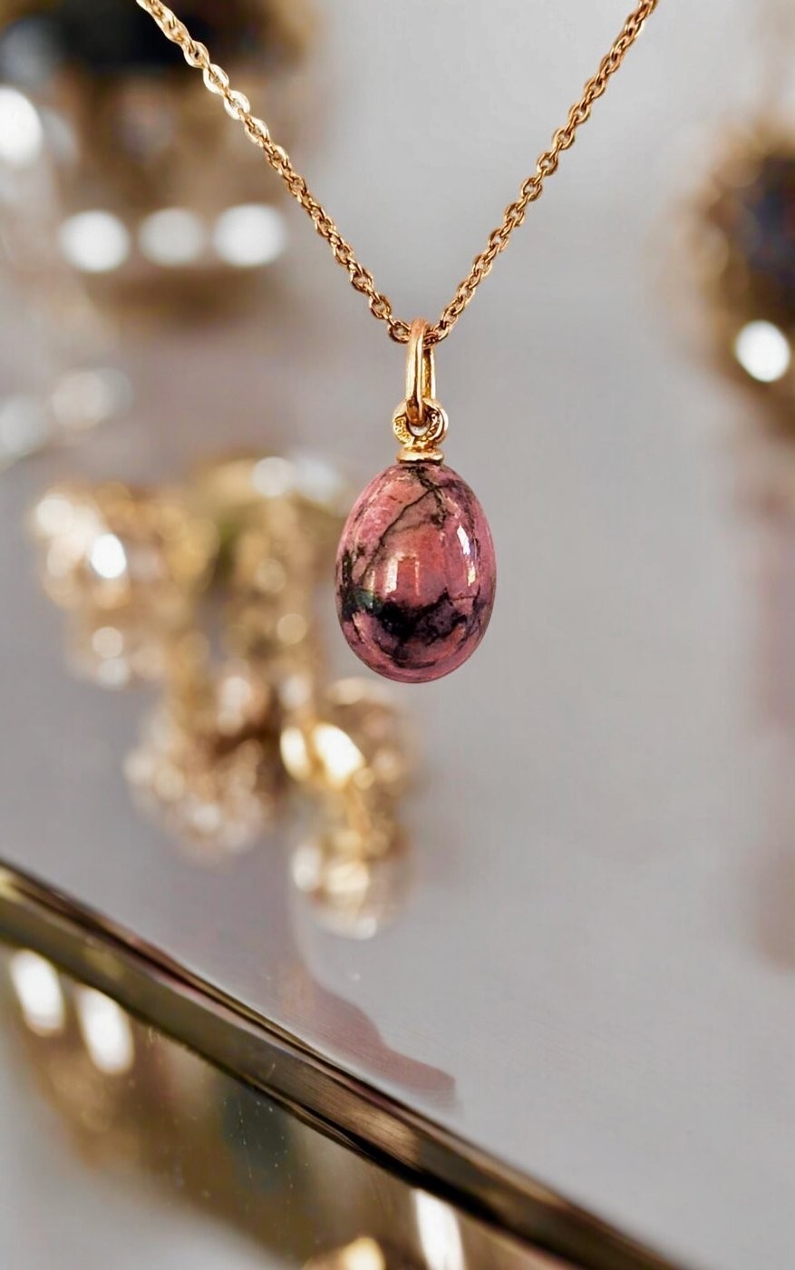 Gold pendant necklace with pink oval stone drop and gold loop bail