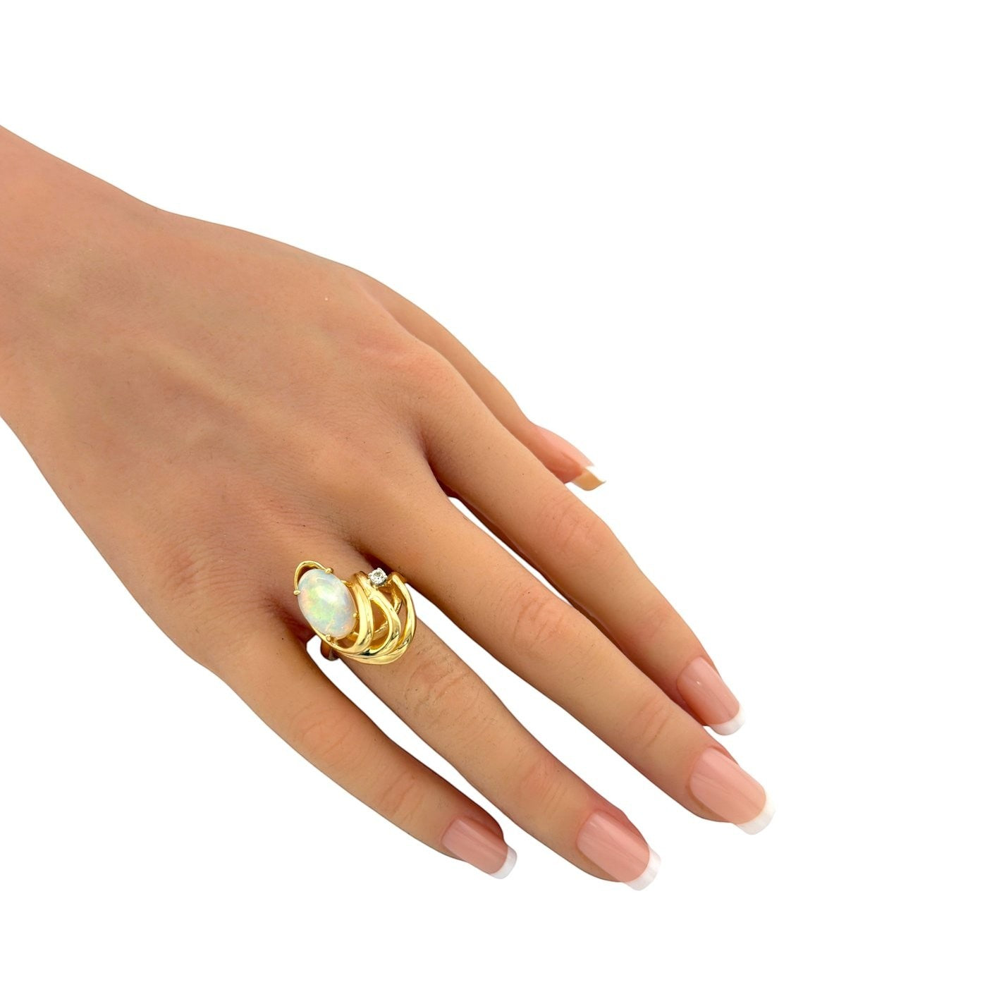 14K yellow gold opal ring on finger, oval opal with small diamond detail