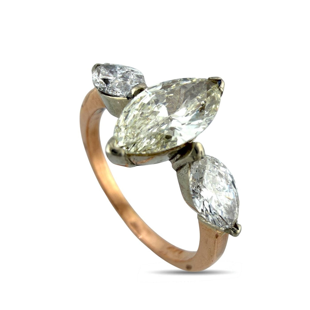 Rose gold marquise diamond ring with three marquise stones on an open band