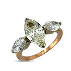 Rose gold band marquise diamond ring with large center stone and two side stones