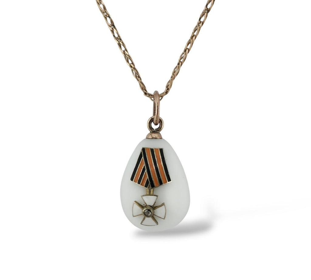 Teardrop enamel egg pendant with striped ribbon and gold flower insignia on chain