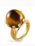 18K yellow gold ring featuring a large tiger’s eye cabochon in split prong setting