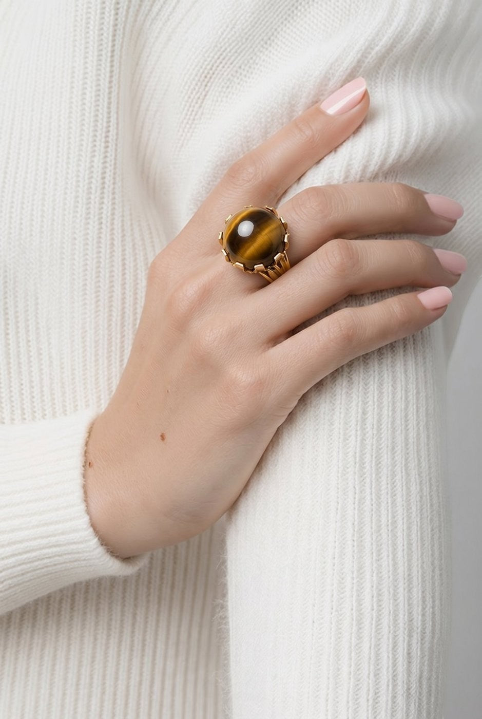 18K yellow gold tiger’s eye ring on hand, round brown-gold cabochon bezel