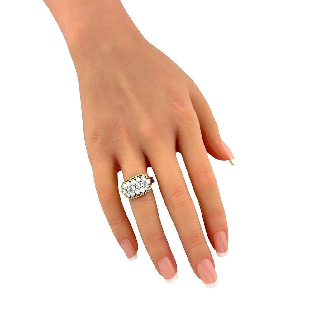 Two-tone 14K gold diamond cluster ring on finger with round white stones