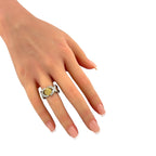 Gold and platinum diamond ring on hand with textured gold basket band