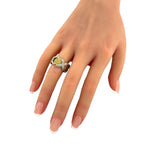 Gold and platinum diamond ring with textured basket band, worn on hand