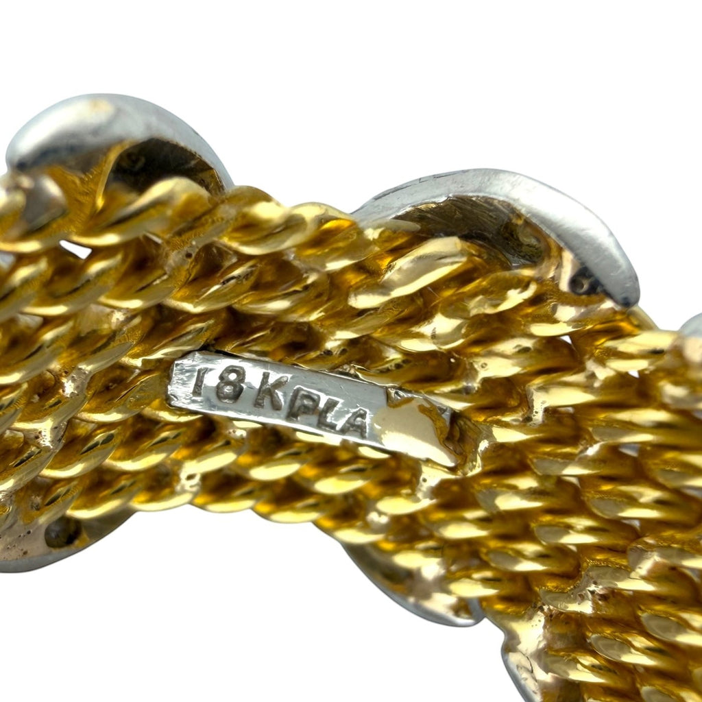 Gold mesh ring close-up with engraved 18k marking on metal