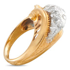 Gold and platinum diamond ring close-up, gold prong setting with textured diamond oval