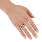 Gold and platinum diamond ring on hand, oval textured top with pave-set look