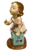 LLADRO My First Step porcelain figurine of child holding a light blue cube