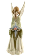 Porcelain angel figurine holding a star, light green robe and white wings
