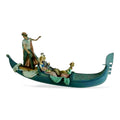 Teal porcelain gondola figurine with seated figures and standing rower, hand-painted
