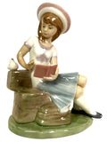 LLADRO porcelain girl figurine seated, holding a book on a green base