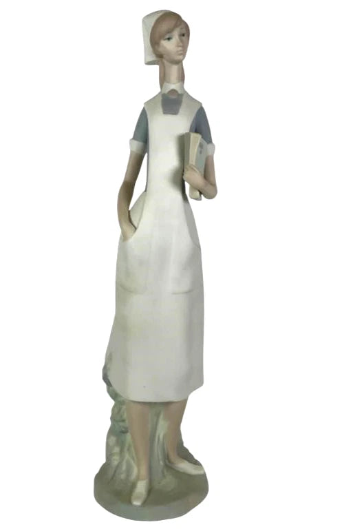 Lladro  Vintage Limited Edition Nurse Figurine 4603 – Porcelain figurine by Lladro depicting a nurse holding a book and medic