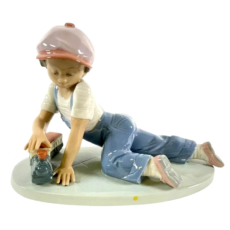 Lladro  Vintage Limited Edition All Aboard  7619 – Lladro All Aboard #7619 porcelain figurine depicting a young boy in overal