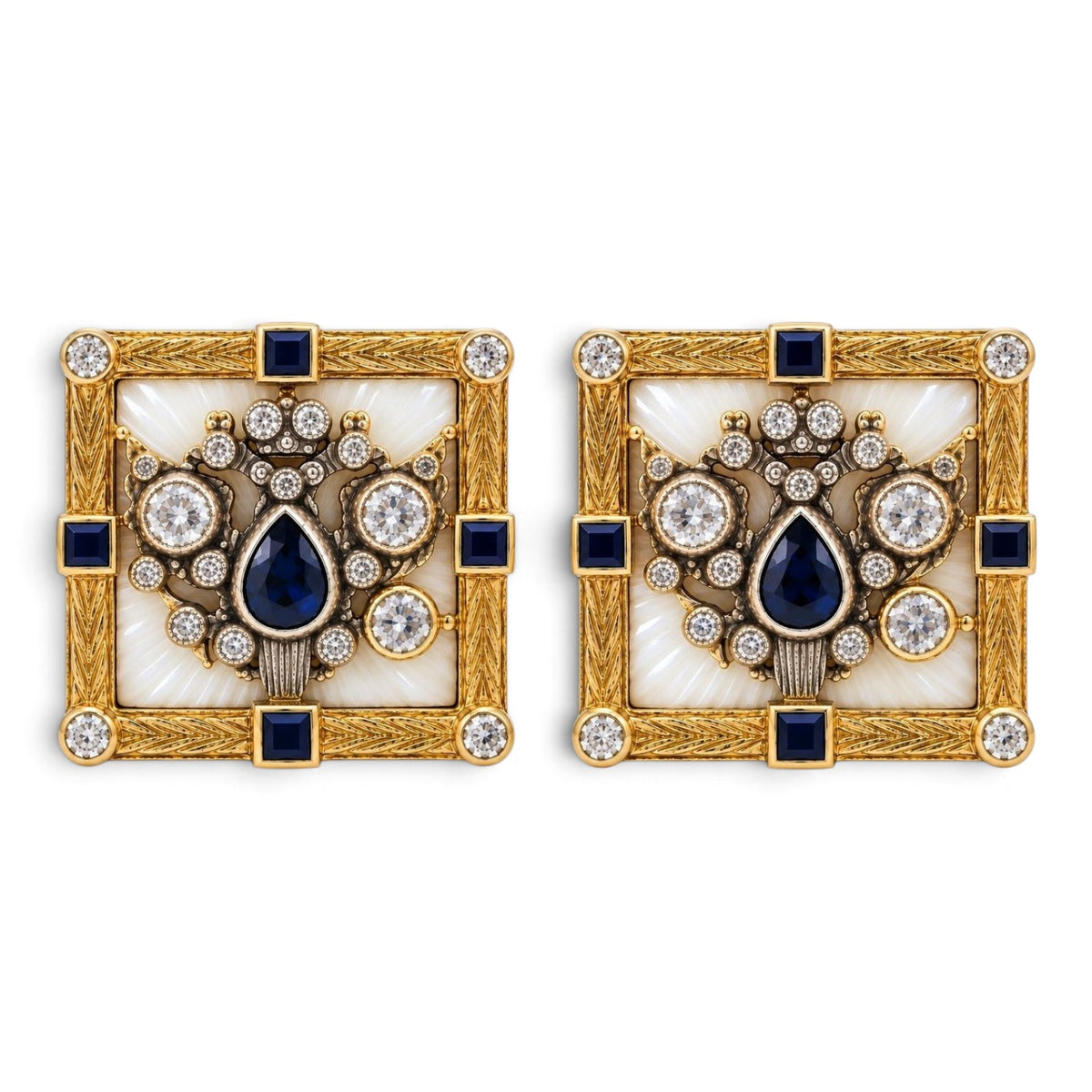 Two square gold cufflinks with blue center stone, halo of clear gems, and black accents